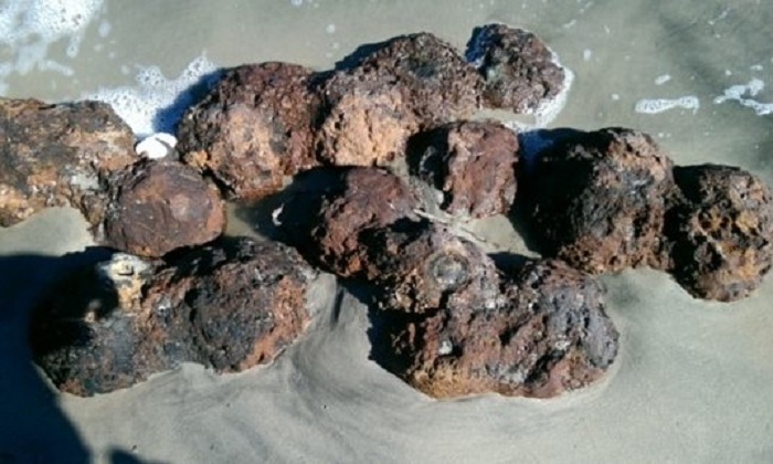 US civil war cannonballs unearthed on beach after Hurricane Matthew